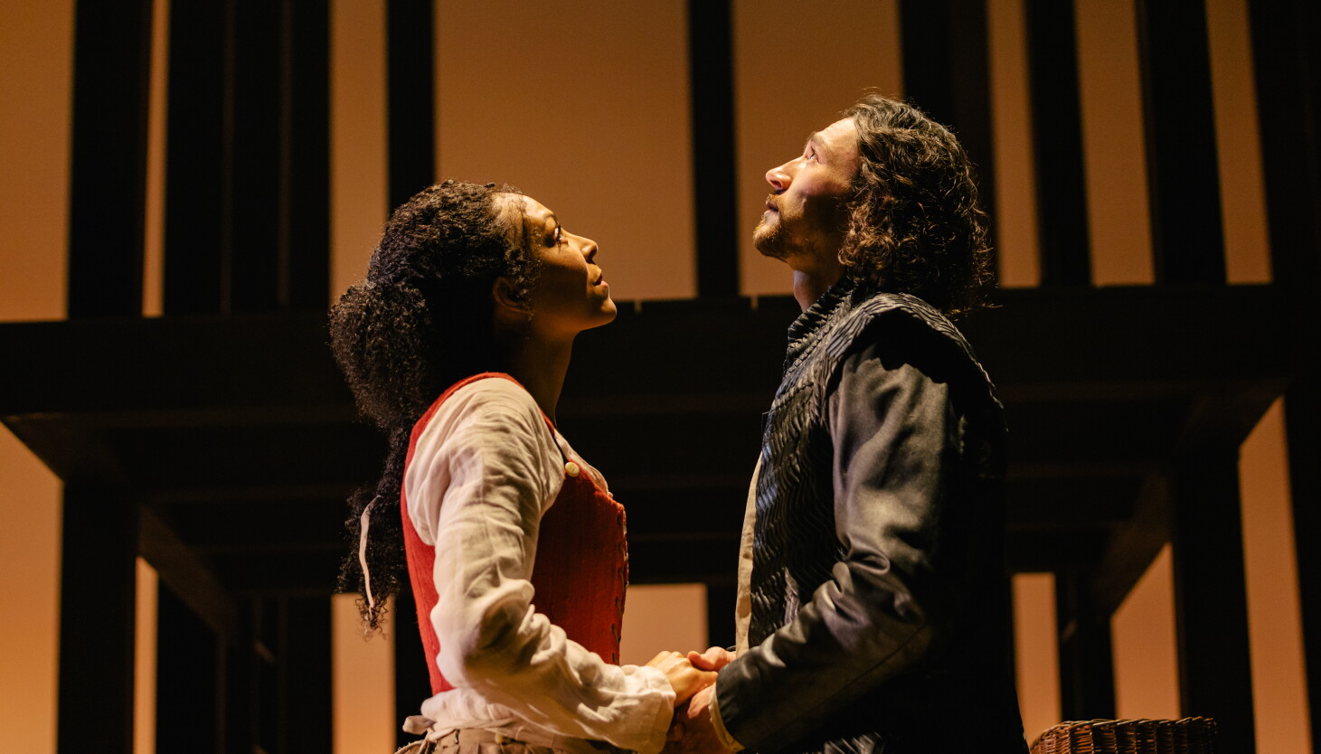 Kemi-Bo Jacobs and Rory Alexander as Agnes and William, holding hands in the US production of Hamnet.